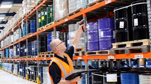 Worker inspects specialty ingredients in a warehouse.