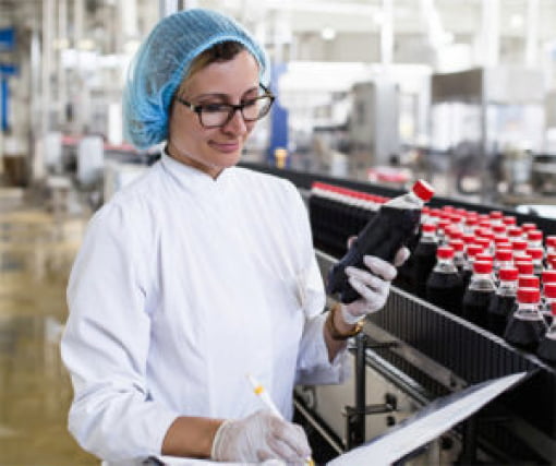 Scientist inspecting bottled products on the manufacturing line