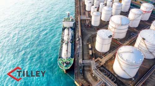 Overhead view of a ship near an oil refinery.