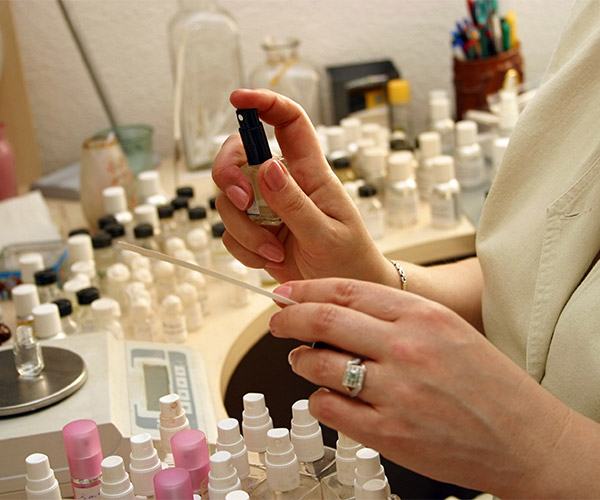 Upclose shot of woman's hands spraying perfume fragrances.