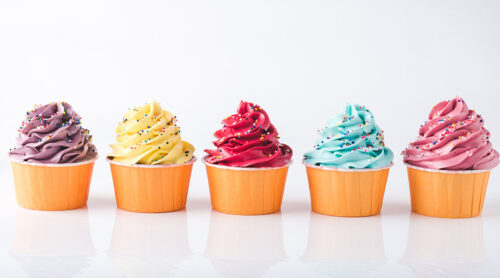 Five brightly color cupcakes.