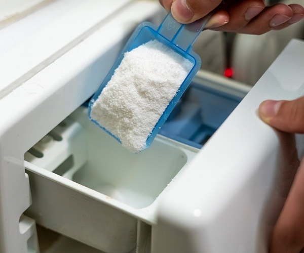 man putting washing powder