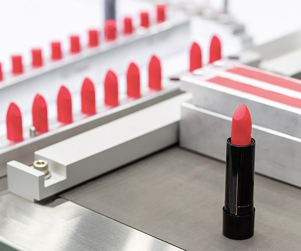 Pink lipstick on a production line.