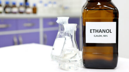 A bottle and two beakers of ethanol.