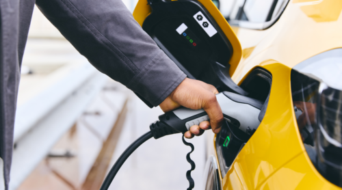 A person charges their electric vehicle.