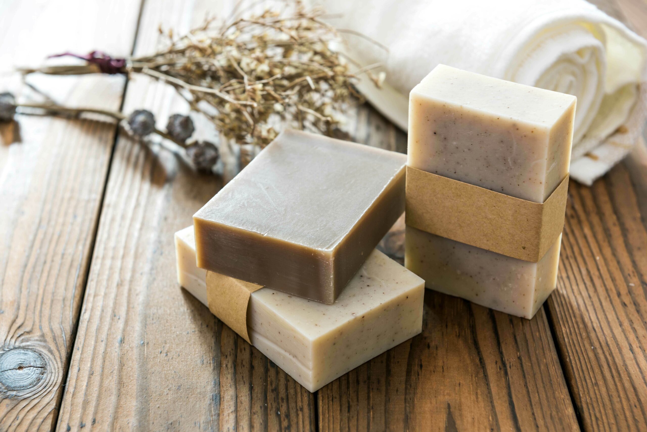 Several bars of soap sitting on a wooden table